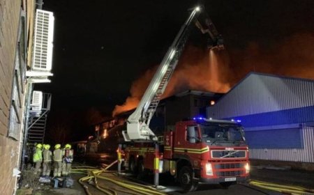 Huge fire rips through carpet factory as people warned to 'avoid the area'